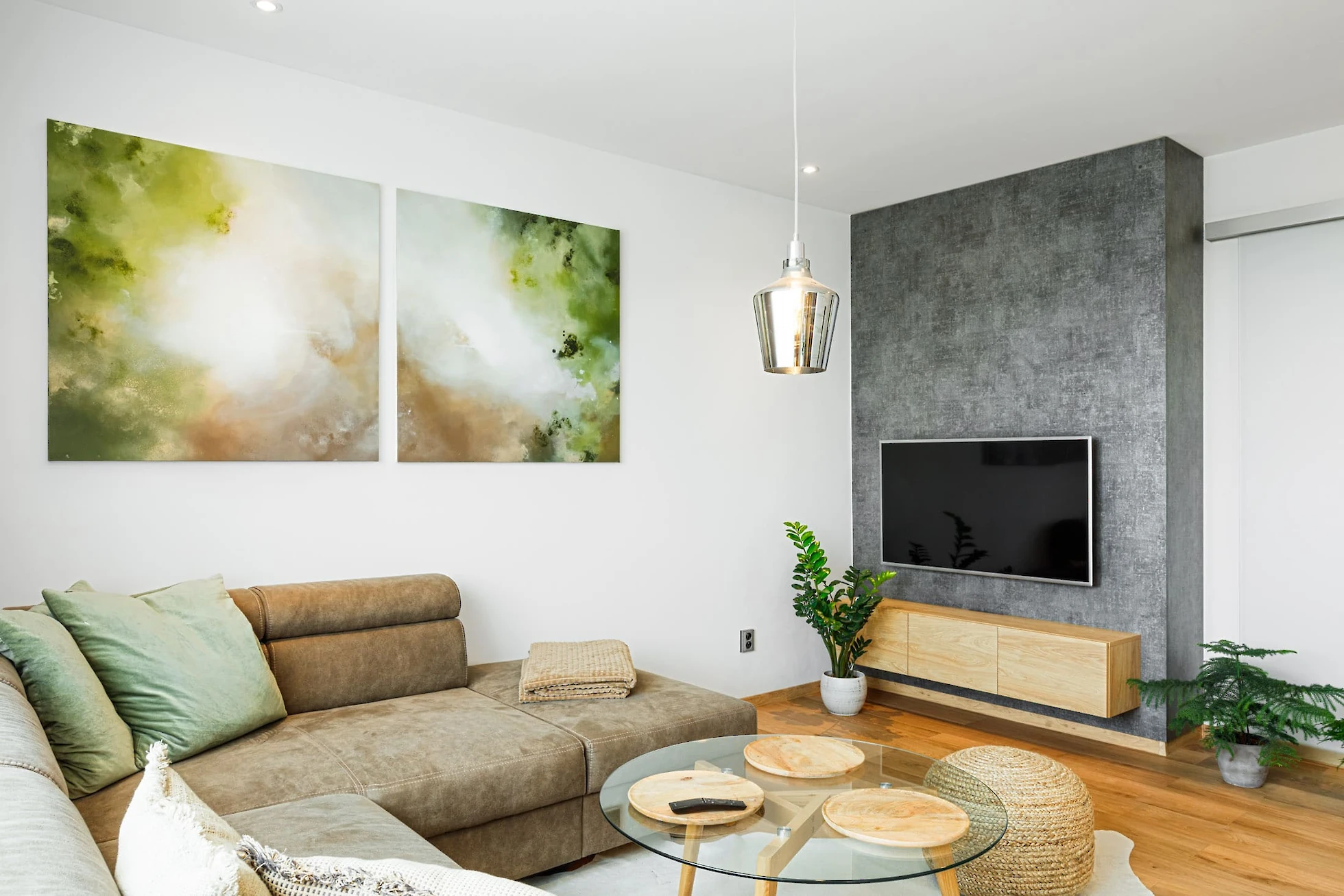 Obývací pokoj s pohodlným gaučem a televizní stěnou